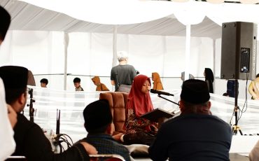 a group of people sitting around a stage